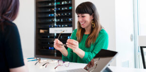 Woman trying on designer glasses
