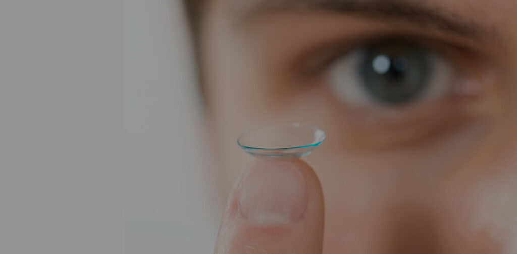 Woman Holding Contact Lense At Vision Specialists