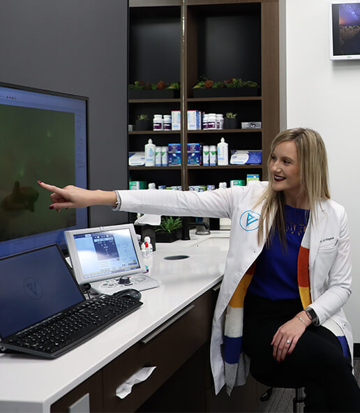 Dr. Lexye Bruegemen pointing at a computer at Vision Specialist Southwest Omaha