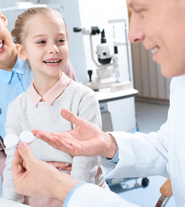 Girl applying atropine eye drops