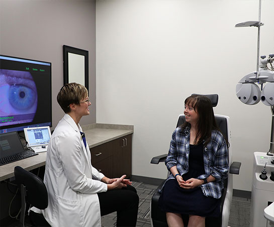Optometrist speaking with patient during eye exam at Vision Specialists in Omaha, NE