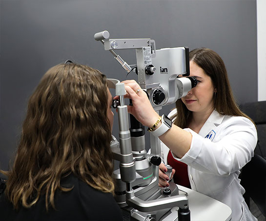 Eye doctor conducting eye exam with equipment at Vision Specialists in Omaha, NE