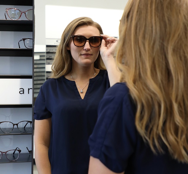 Woman trying on prescription sunglasses at Vision Specialists